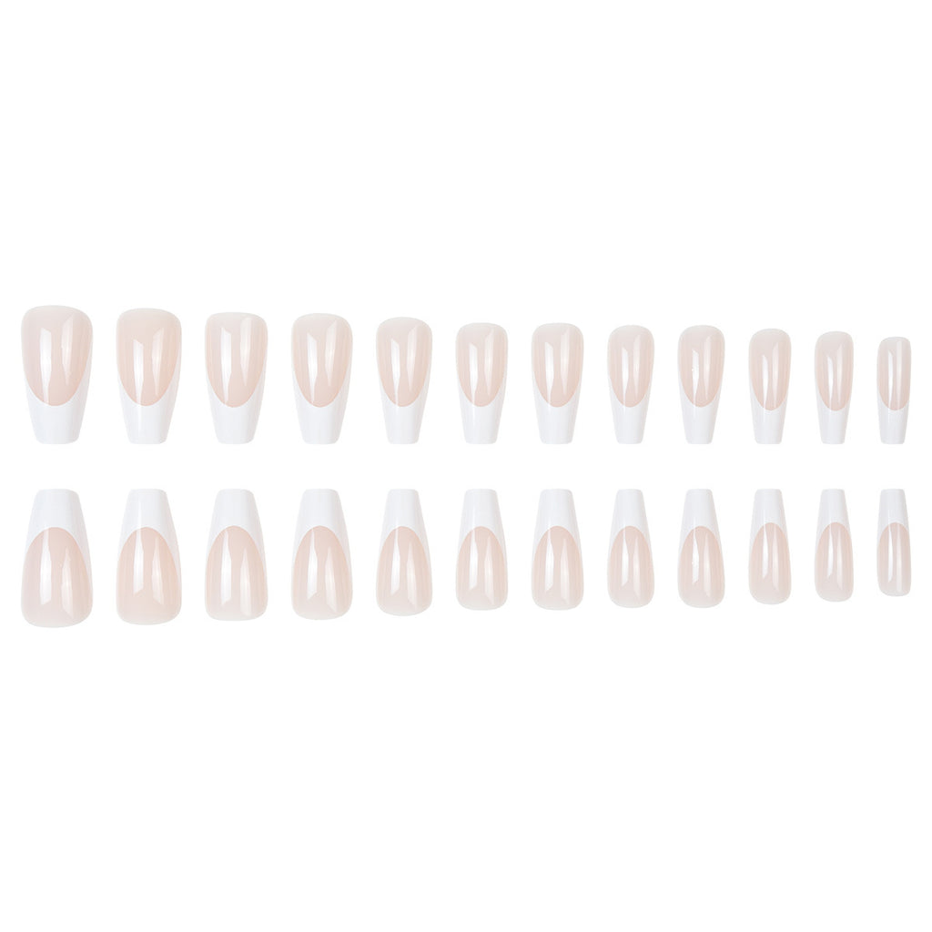 Set of sheer nude press-on tips with white French detailing in oval shapes