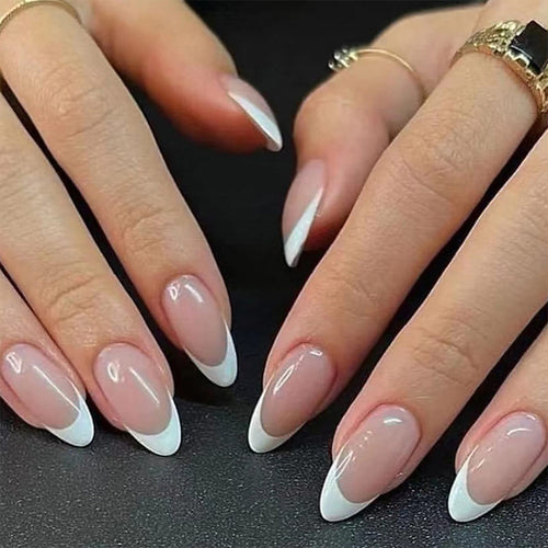 Almond press-on nails with clear pink base and white icy French tips on hands