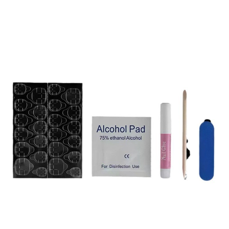 Press-on nail kit items: alcohol pad, adhesive tube, nude nail tips, blue sanding block