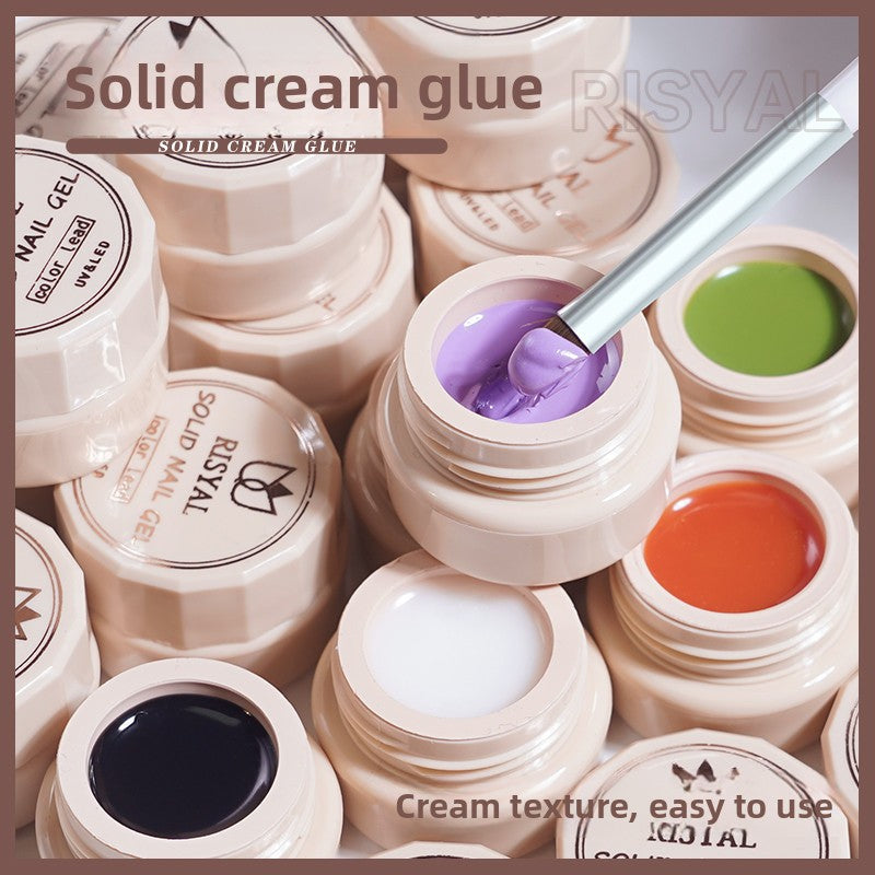 Solid cream nail glue with open jar of purple gel, plus green and orange jars