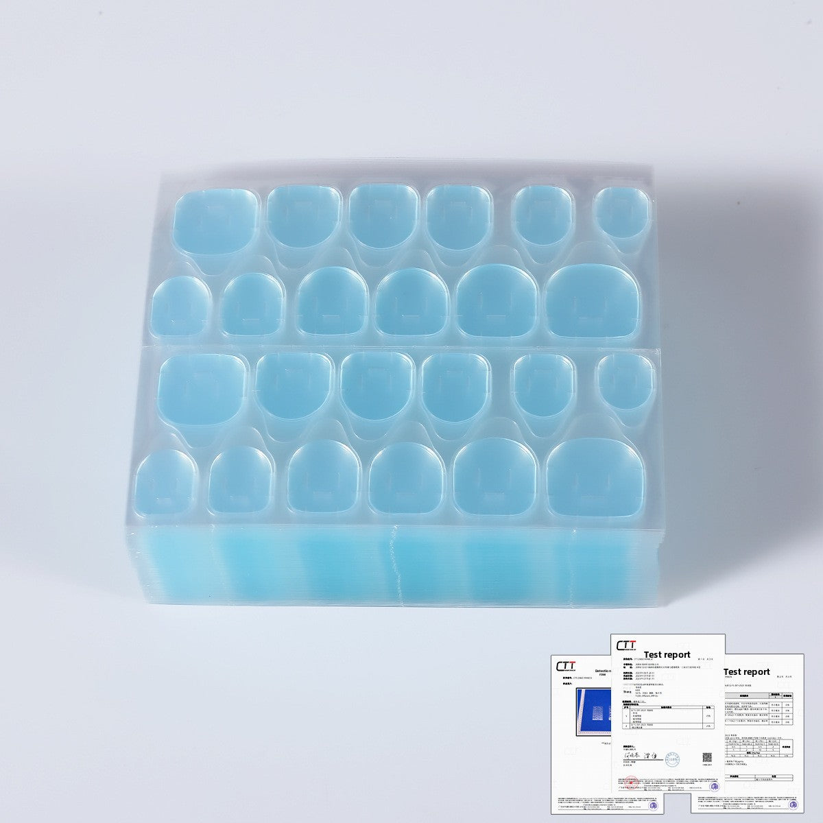 Blue nail jelly glue in clear organizer tray with multiple curved nail caps