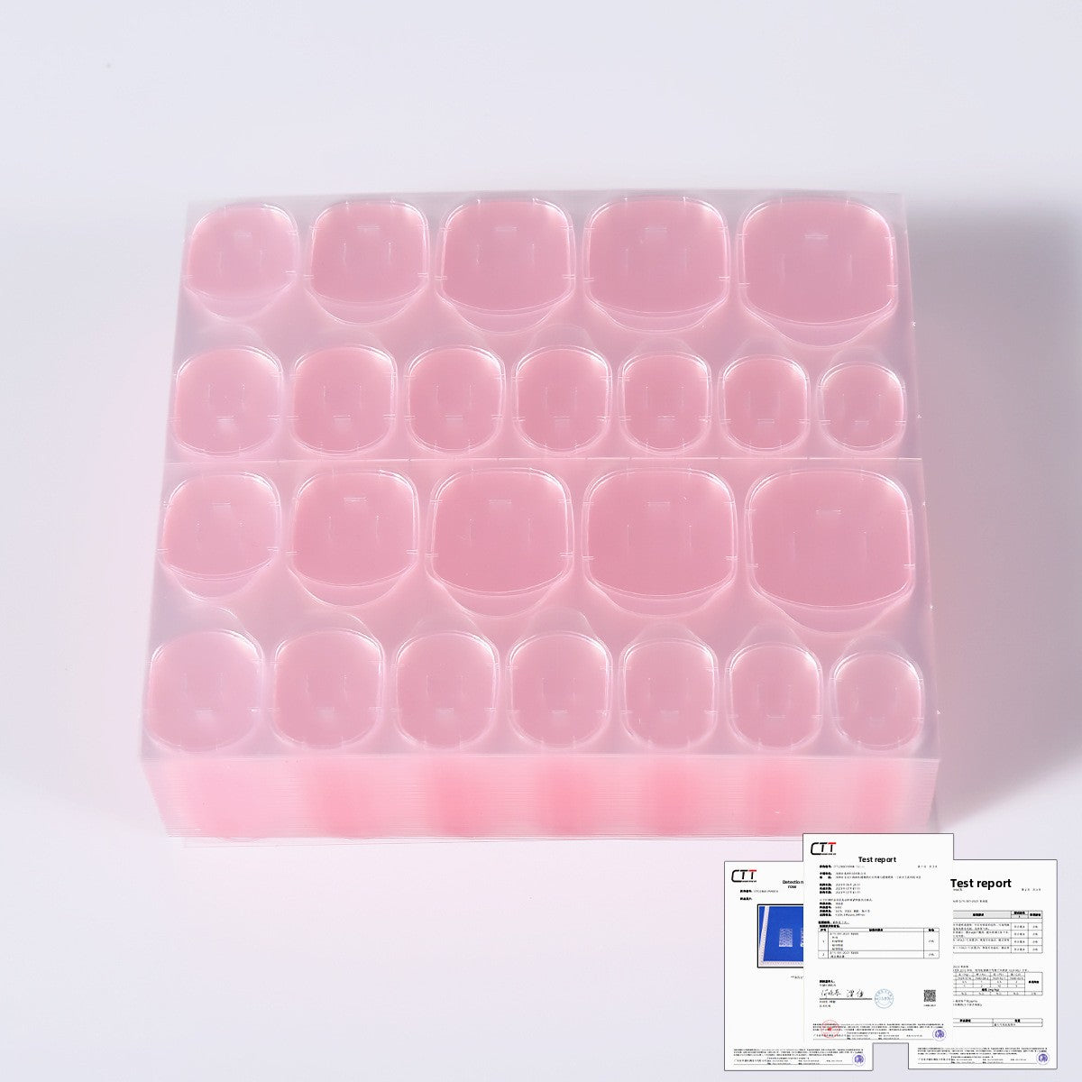 Pink gel nail tips in a clear tray, compact rows of short rounded-square pieces