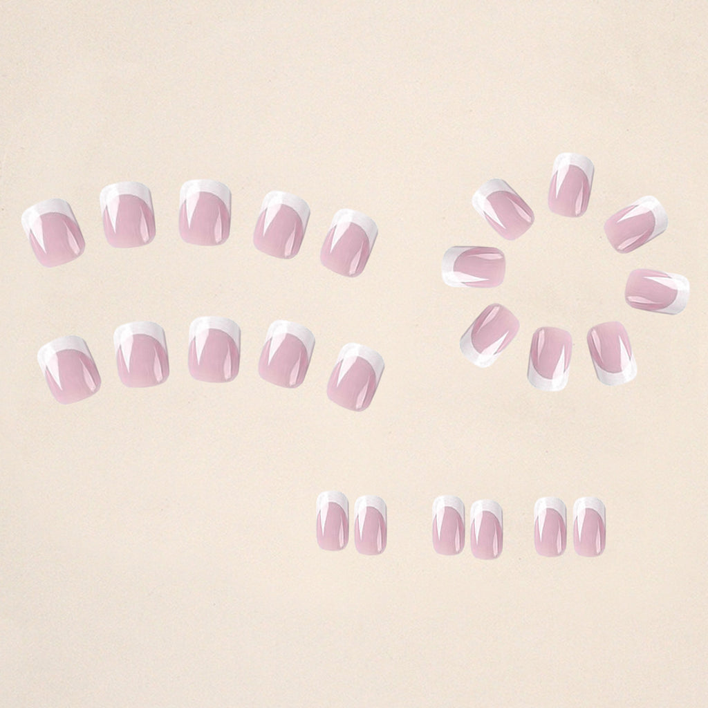 Set of false nails arranged: sheer pink with white French tips and small glitter dots