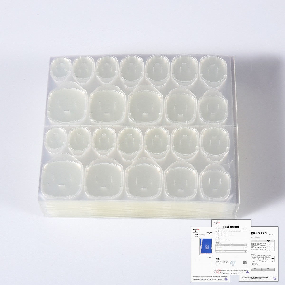 Plastic tray of clear nail jelly glue gel tips; test report paper visible to the side